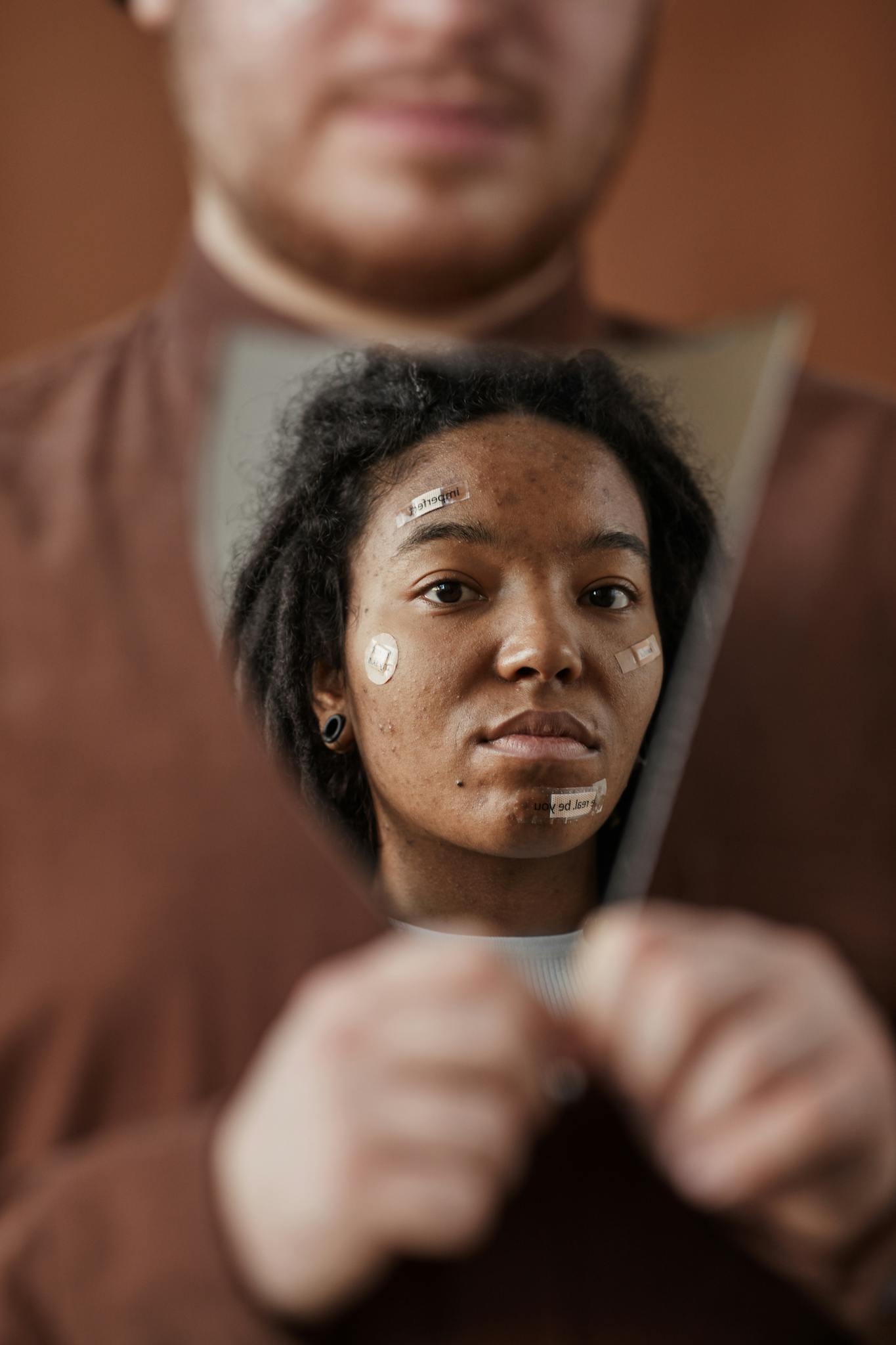 A Woman With Skincare Patches Reflecting In